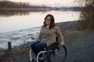 woman in wheelchair near lake